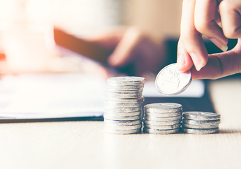 An individual stacking coins