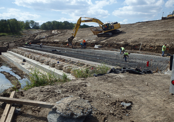A backhoe operating during the construction of Weir Dam