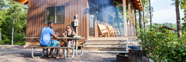 A family eating a meal in front of a sleeping cabin at a Missouri State Park